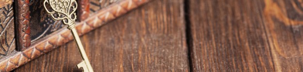 vintage key and old treasure chest on wooden table