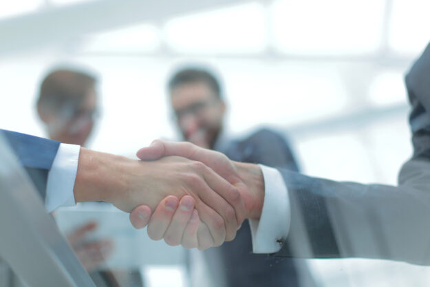 Business men shaking hands. Closeup.