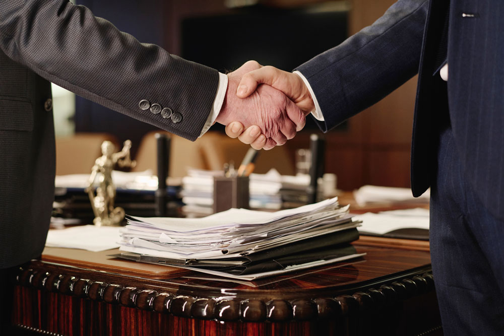 two-business-partners-shaking-hands-after-negotiat-2024-01-26-18-39-56-utc